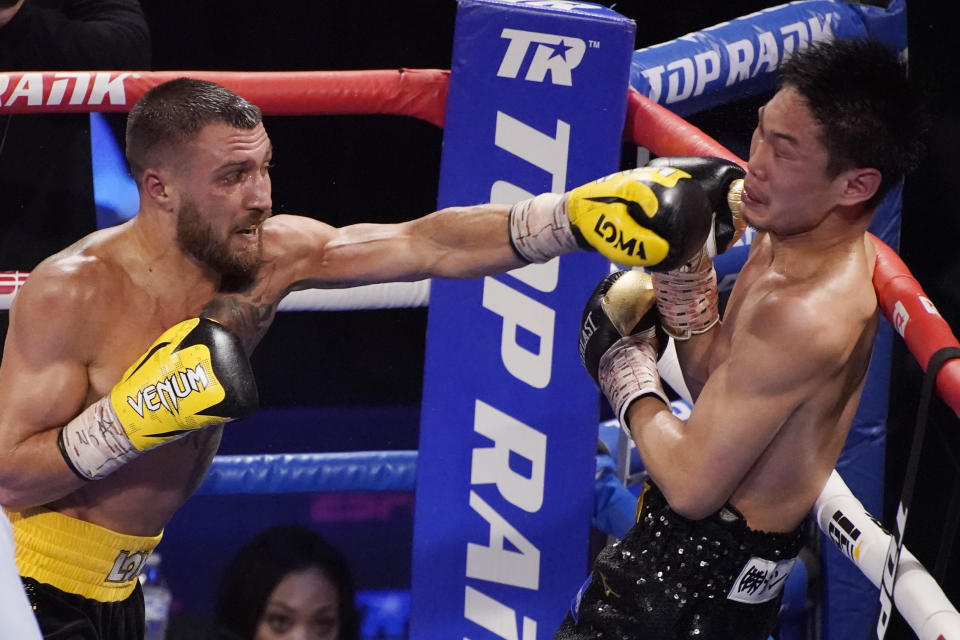 Vasiliy Lomachenko, of Ukraine, hits Masayoshi Nakatani, of Japan, during a lightweight bout Saturday, June 26, 2021, in Las Vegas. (AP Photo/John Locher)