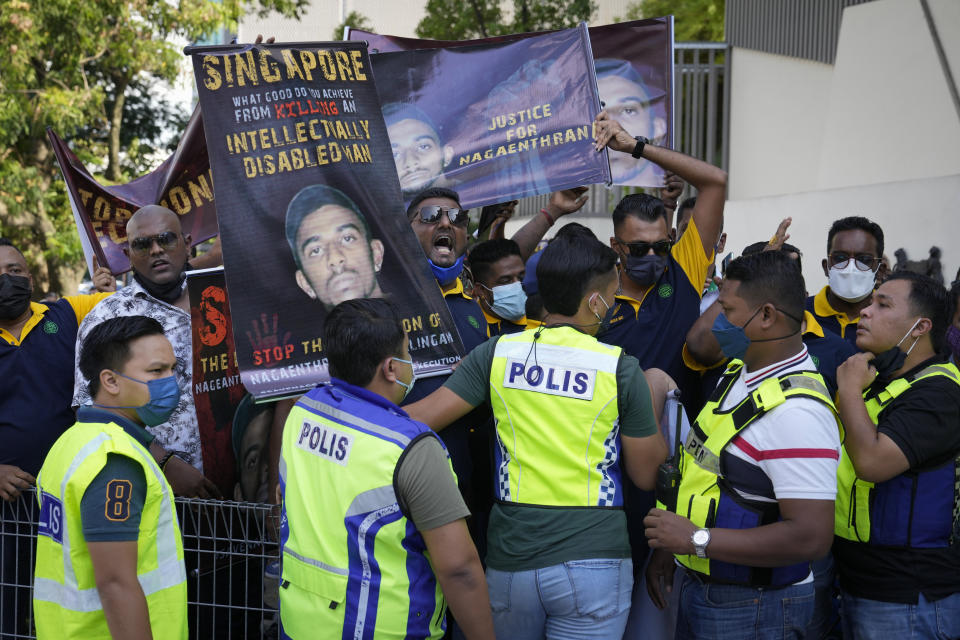 FILE - Activists hold banners against the impending execution of Nagaenthran K. Dharmalingam, sentenced to death for trafficking heroin into Singapore, during a gathering outside the Singaporean Embassy in Kuala Lumpur, Malaysia, Saturday, April 23, 2022. The Singapore Court of Appeal on Tuesday, April 26, 2022, dismissed a legal challenge filed by Dharmalingam’s mother, as part of a last-minute attempt to halt the execution of his death sentence. (AP Photo/Vincent Thian, File)