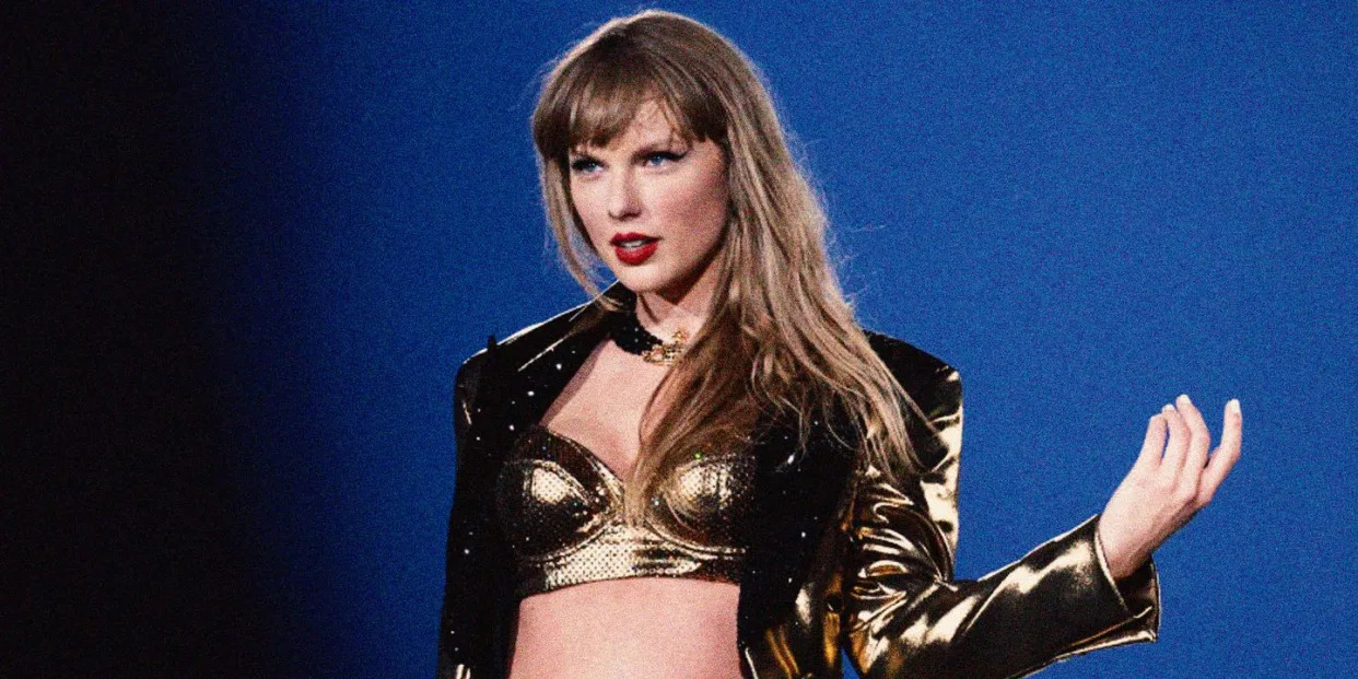 taylor swift on stage in a gold bra and jacket