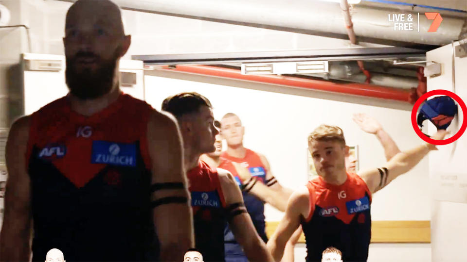 Melbourne Demons players, pictured here touching Angus Brayshaw's helmet before their AFL clash.