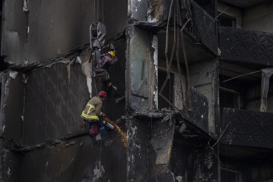 Firefighters work on a destroyed apartment building in the town of Borodyanka, Ukraine, on Saturday, April 9, 2022. Russian troops occupied the town of Borodyanka for weeks. Several apartment buildings were destroyed during fighting between the Russian troops and the Ukrainian forces in the town around 40 miles northwest of Kiev. (AP Photo/Petros Giannakouris)