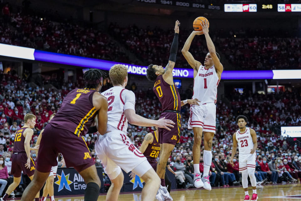 Wisconsin's Johnny Davis (1) shoots against Minnesota's Eric Curry (1) during the second half of an NCAA college basketball game Sunday, Jan. 30, 2022, in Madison, Wis. Wisconsin won 66-60. (AP Photo/Andy Manis)