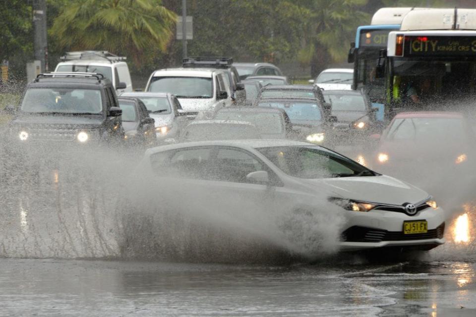 Car drives along flooded road