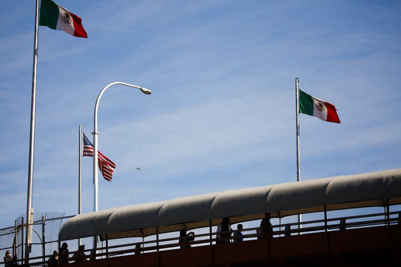 Migrants under the Migrant Protection Protocols (MPP) program walk to Mexico across the Lerdo-Stanton International Bridge after being returned from the U.S. to Mexico to continue their asylum application, in Ciudad Juarez, Mexico