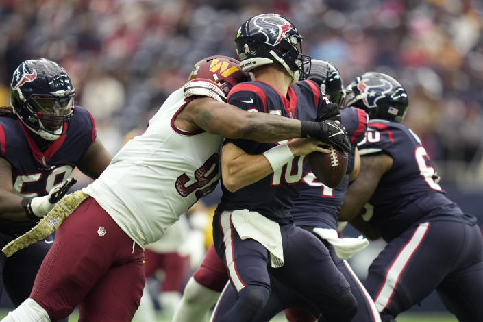 Houston Texans quarterback Davis Mills (10) is sacked by Washington Commanders defensive end Montez Sweat (90) during the first half of an NFL football game Sunday, Nov. 20, 2022, in Houston. (AP Photo/Eric Christian Smith)