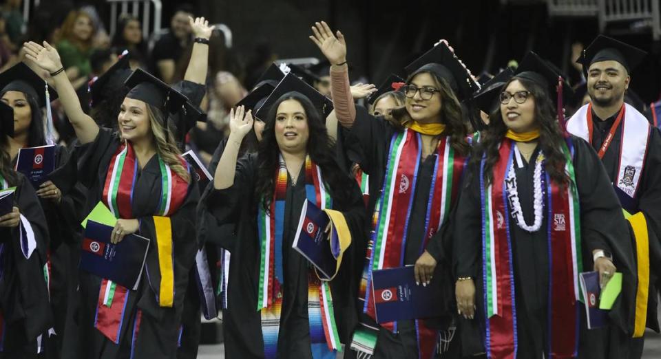 Graduates walk into the Save Mart Center during the Fresno State Latino/Chicano Commencement Celebration on May 21, 2022.