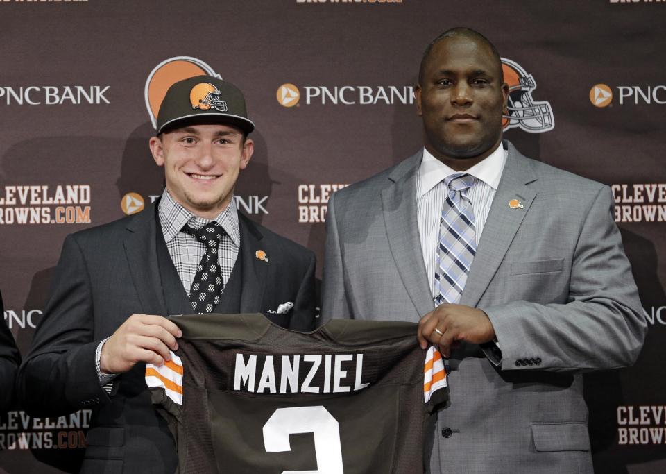 Cleveland Browns quarterback Johnny Manziel, from Texas A&M, holds his new jersey with general manager Ray Farmer at the NFL football team's facility in Berea, Ohio Friday, May 9, 2014. The Browns selected Manziel with the 22nd overall pick in Thursday's NFL draft. (AP Photo/Tony Dejak)