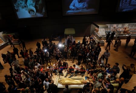 Members of the media are seen around the Gold Coffin of Nedjemankh during a news conference to announce its return from the U.S. and display at the National Museum of Egyptian Civilization (NMEC) in Cairo