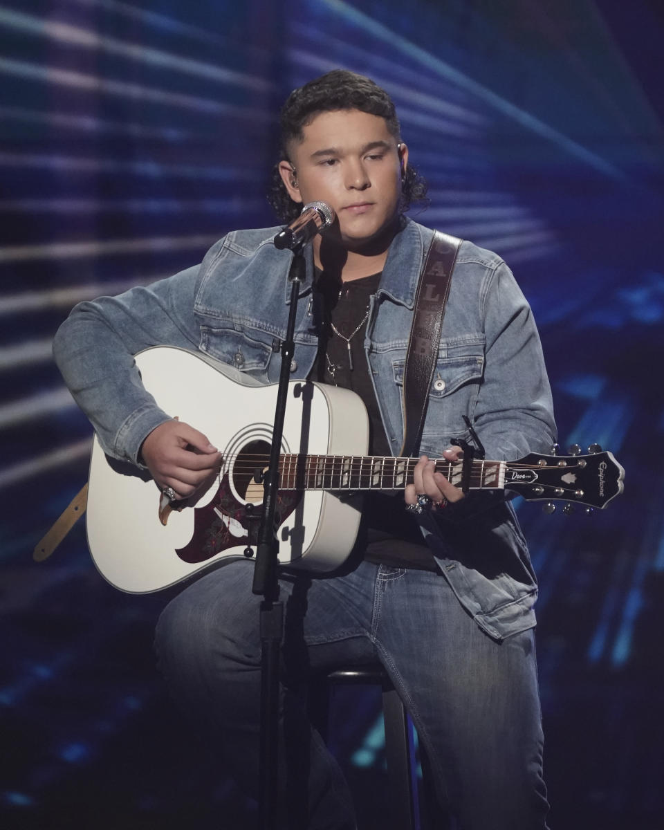 This image released by ABC shows Caleb Kennedy performing on the singing competition series "American Idol," in Los Angeles that aired May 9. Kennedy has dropped out of the singing competition after a video circulated showing him sitting next to someone wearing what appears to be a Ku Klux Klan hood. Kennedy, advanced into the Top 5, apologized for the video on Twitter and Instagram on Wednesday, saying “it displayed actions that were not meant to be taken in that way.” (Eric McCandless/ABC via AP)