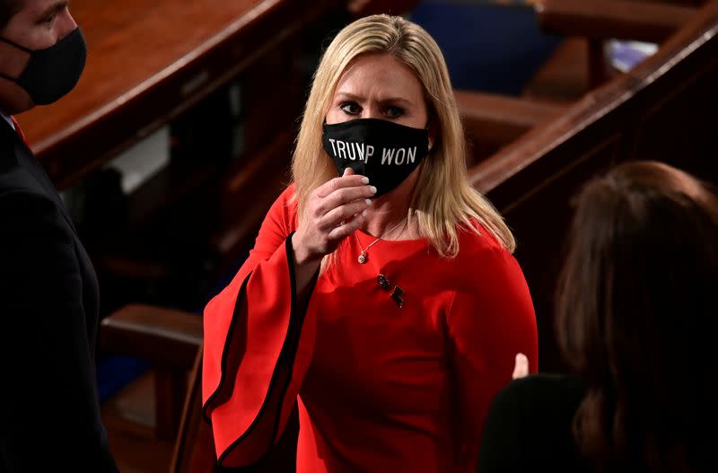 FILE PHOTO: U.S. Rep. Marjorie Taylor Greene (R-GA) wears a "Trump Won" face mask as she arrives to take her oath of office as a member of the 117th Congress in Washington