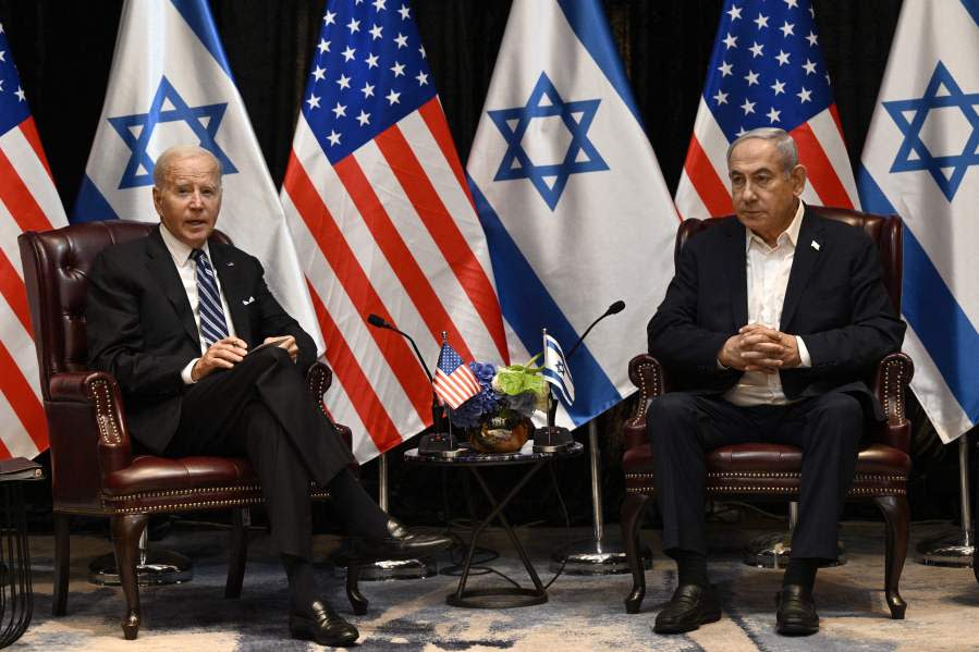 TOPSHOT – US President Joe Biden (L) listens to Israel’s Prime Minister Benjamin Netanyahu as he joins a meeting of the Israeli war cabinet in Tel Aviv on October 18, 2023, amid the ongoing battles between Israel and the Palestinian group Hamas. US President Joe Biden landed in Tel Aviv on October 18, 2023 as Middle East anger flared after hundreds were killed when a rocket struck a hospital in war-torn Gaza, with Israel and the Palestinians quick to trade blame. (Photo by Brendan SMIALOWSKI / AFP) (Photo by BRENDAN SMIALOWSKI/AFP via Getty Images)