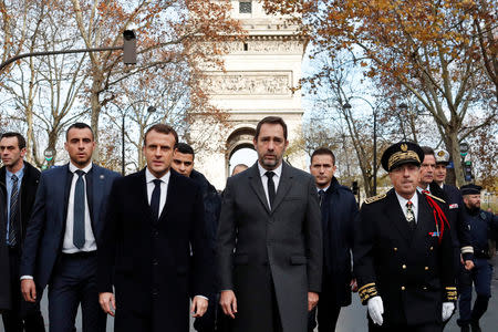 France's President Emmanuel Macron, France's Interior Minister Christophe Castaner and Paris police Prefect Michel Delpuech arrive to visit firefighters and riot police officers the day after a demonstration, in Paris, France December 2, 2018. Thibault Camus/Pool via REUTERS