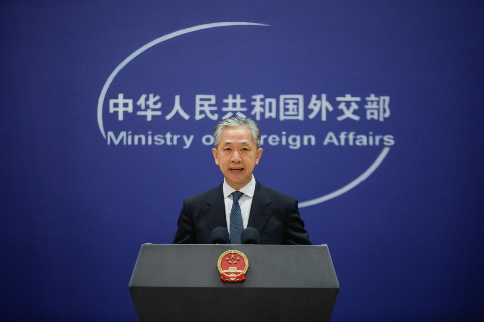 China's Foreign Ministry spokesperson Wang Wenbin pictured on stage.