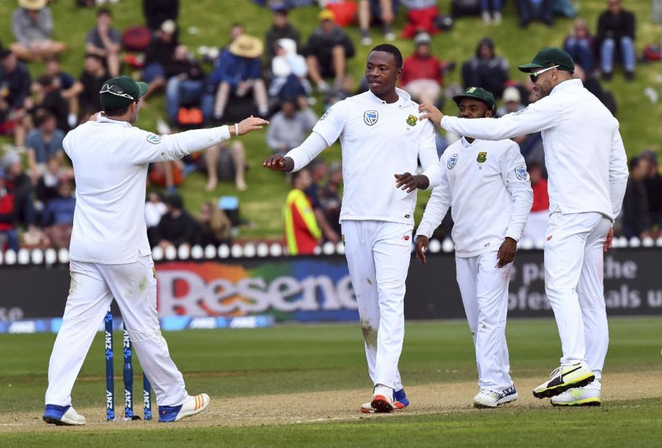 South Africa's Kagiso Rabada, center, celebrates with his teammates after dismissing New Zealand's Jeetan Patel for 0 during the second cricket test at the Basin Reserve in Wellington, New Zealand, Saturday, March 18, 2017. (Ross Setford/SNPA via AP)