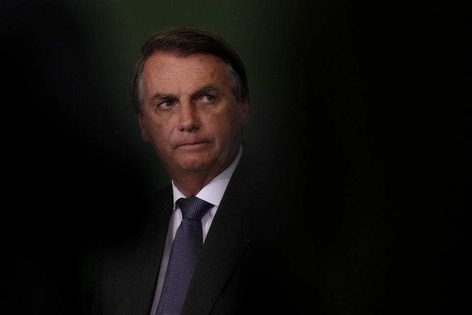 FILE - In this Oct. 25, 2021, file photo, President Jair Bolsonaro attends the launching ceremony of the National Green Growth Program at the Planalto presidential palace in Brasilia, Brazil. A Brazilian Senate committee will vote Tuesday, Oct. 26, on a report recommending Bolsonaro face a series of criminal indictments for actions that allegedly added to the world's second-highest COVID-19 death toll. (AP Photo/Eraldo Peres, File)