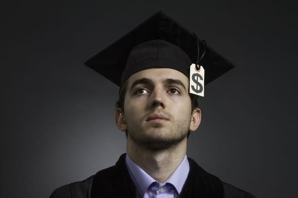 A college grad with a dollar sign attached to his cap.