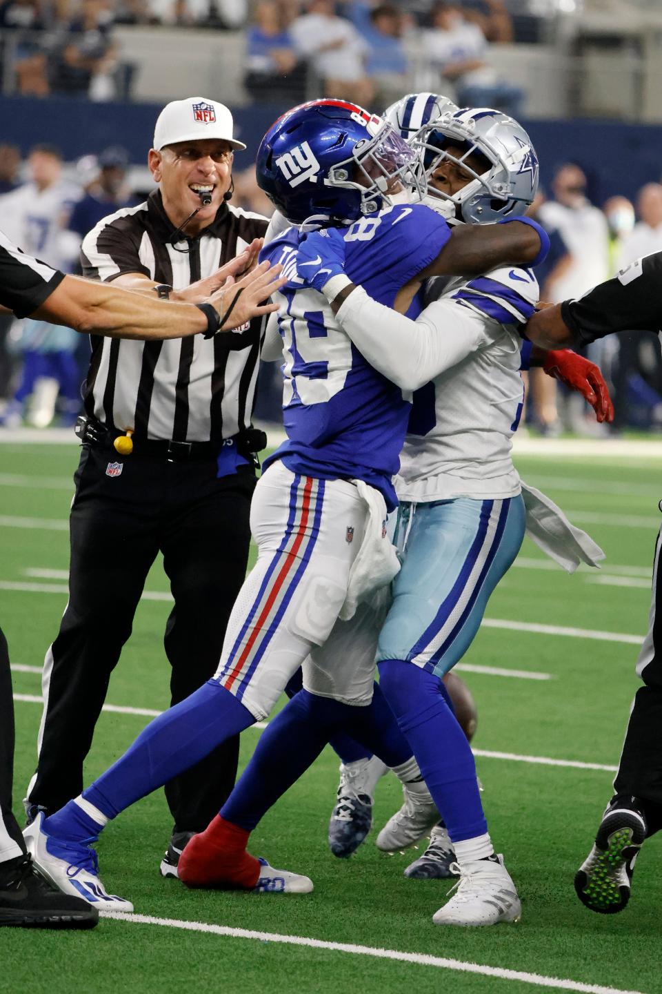 New York Giants wide receiver Kadarius Toney (89) gets tangled up with Dallas Cowboys safety Damontae Kazee, right, after Toney threw a punch at Kazee.