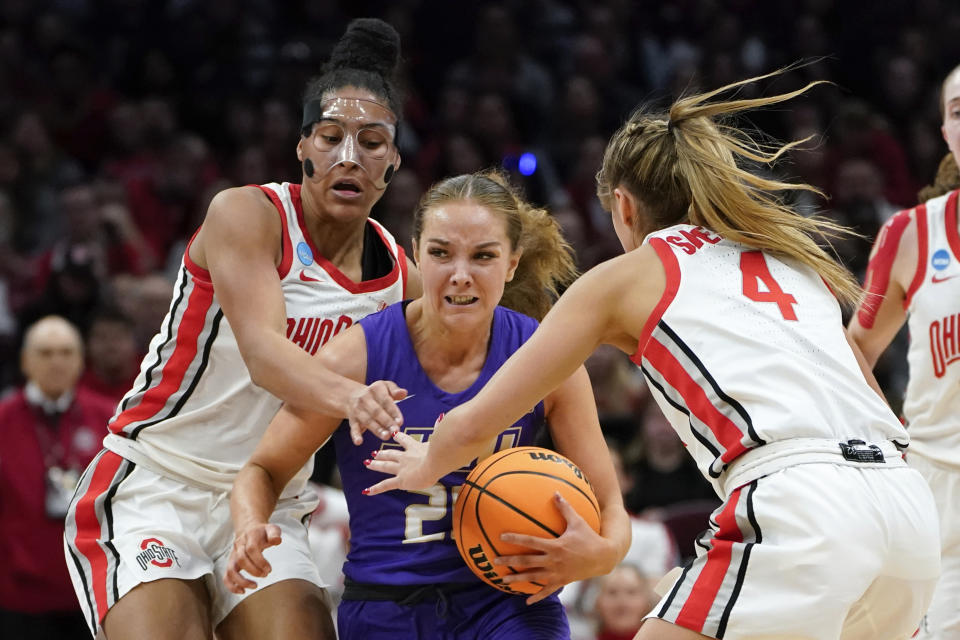 James Madison guard Caroline Germond (20) tries to break the press of Ohio State forward Taylor Thierry, left, and Ohio State guard Jacy Sheldon (4) in the second half of a first-round women's college basketball game in the NCAA Tournament Saturday, March 18, 2023, in Columbus, Ohio. (AP Photo/Paul Sancya)