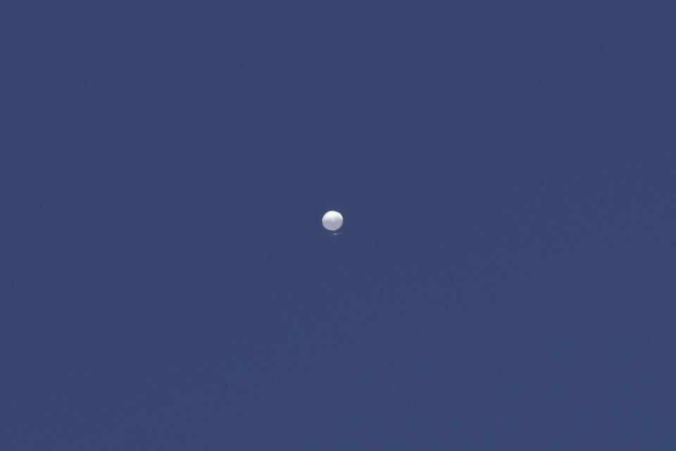 A balloon floats over Columbia, Mo., on Friday, Feb. 3, 2023. A huge, high-altitude Chinese balloon sailed across the U.S. on Friday, drawing severe Pentagon accusations of spying despite China's firm denials. (Anna Griffin/Missourian via AP)