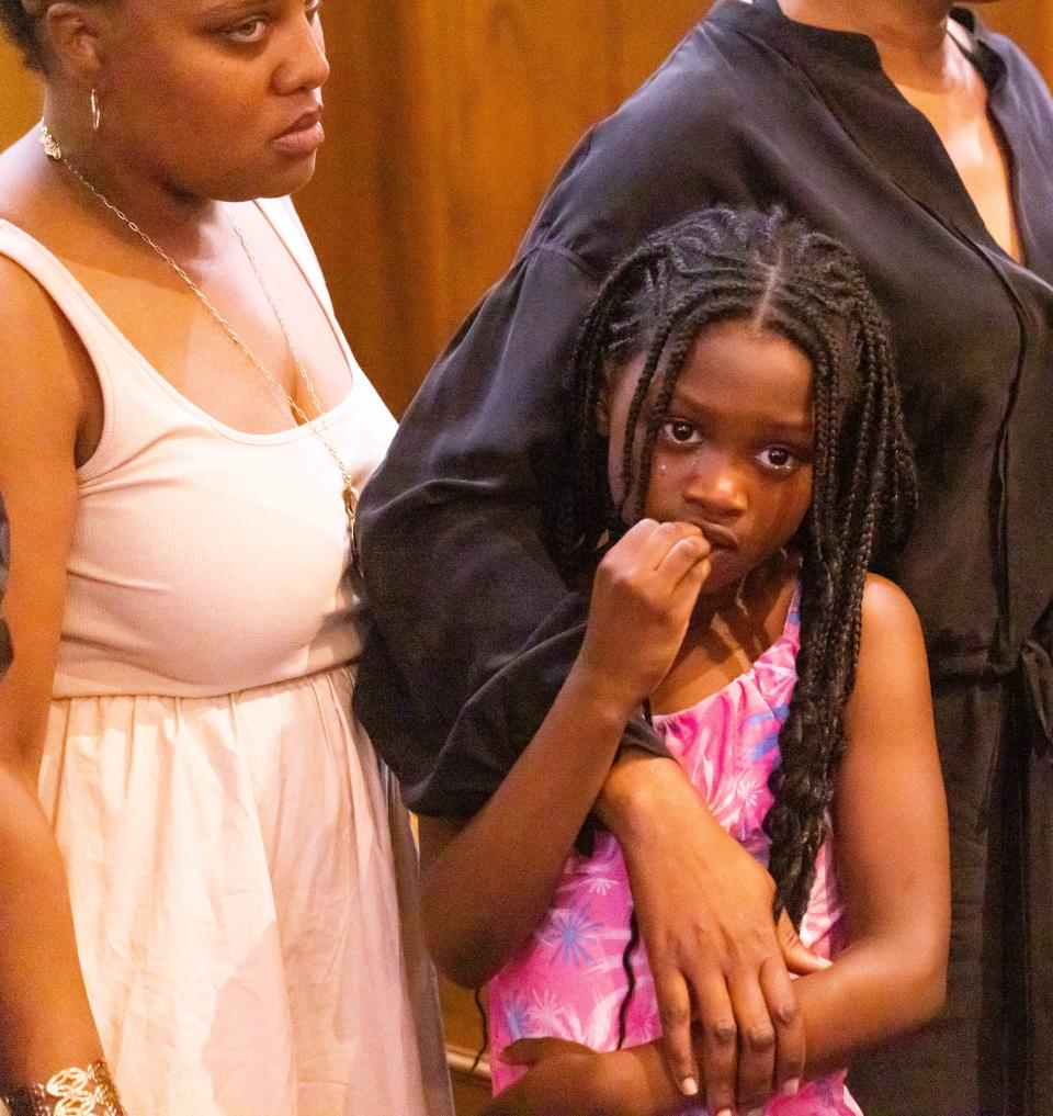 One of the children of Ajike Shantrell Owens, is consoled  during a press conference held at the New St. John Missionary Baptist Church Monday afternoon June 5, 2023, by Attorney Anthony Thomas who is representing the family and the victim Ajike Shantrell Owens. The shooting took place last Friday when a woman shot through her front door killing another woman at Quail Run, a housing complex located off County Road 475A, not far from County Road 484, in Ocala, FL. The victim was identified as Ajike Shantrell Owens. No one has been arrested. [Doug Engle/Ocala Star Banner]2023