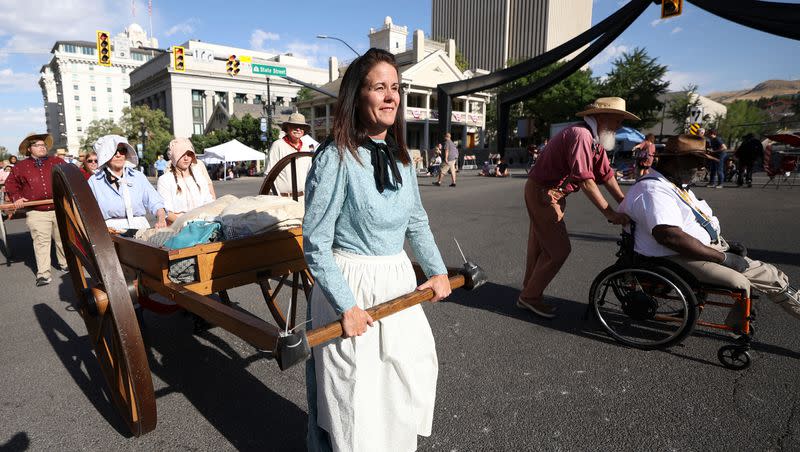 Lisa Smith pulls a handcart in the Days of ’47 Parade in Salt Lake City on Saturday, July 23, 2022.