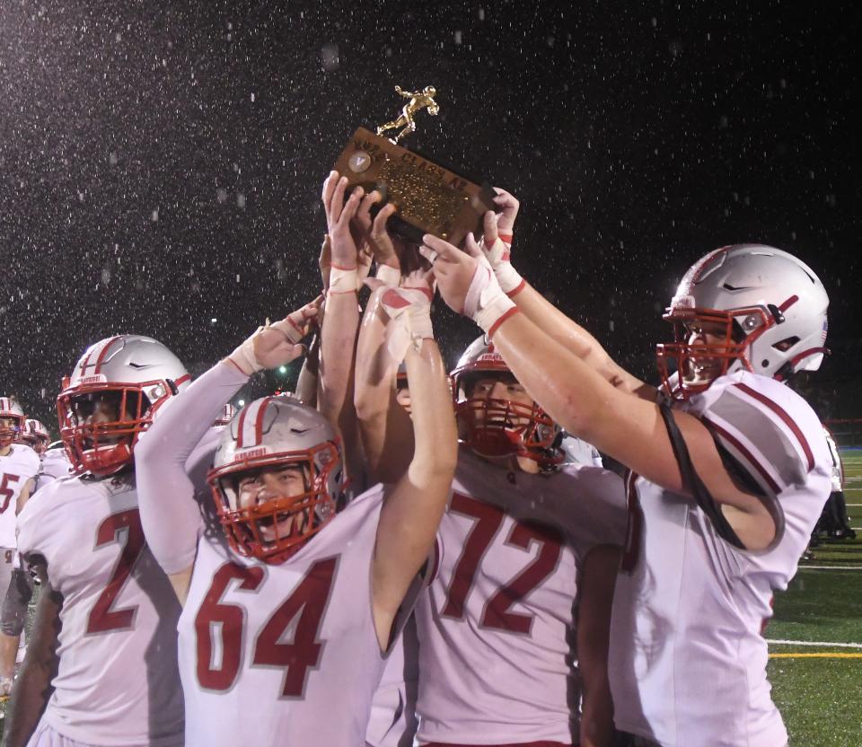 Canandaigua captains hold up the Section V Class A2 title with their win over East on Nov. 11, 2022.