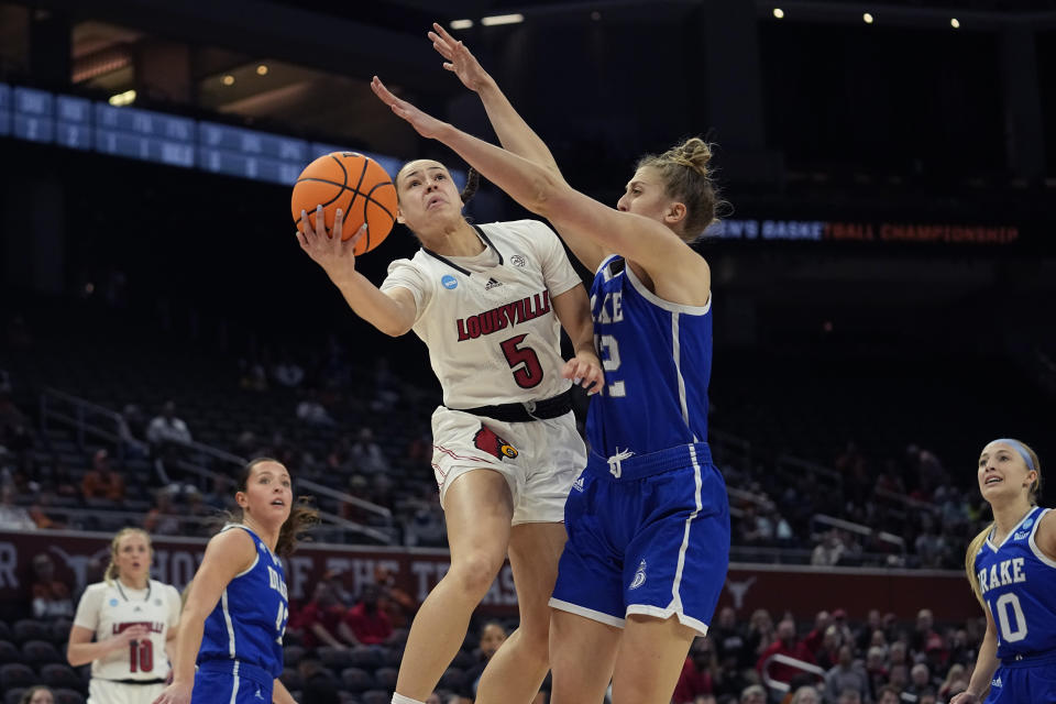Louisville guard Mykasa Robinson (5) drives to the basket against Drake forward Maggie Bair (42) during the first half of a first-round college basketball game in the NCAA Tournament in Austin, Texas, Saturday, March 18, 2023. (AP Photo/Eric Gay)
