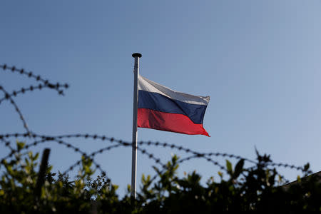 A Russian flag flutters atop the Russian consulate after an explosion, in Athens, Greece March 22, 2019. REUTERS/Costas Baltas