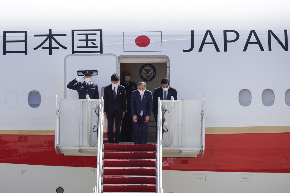 Japanese Prime Minister Yoshihide Suga boards his plane to depart at Andrews Air Force Base, Md., Saturday, April 17, 2021, after his visit to Washington. (AP Photo/Luis M. Alvarez)