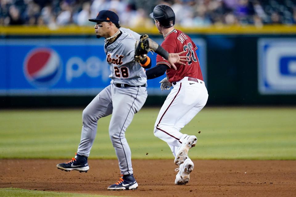 Tigers shortstop Javier Baez tags out Diamondbacks right fielder Pavin Smith, right, during the fourth inning on Sunday, June 26, 2022, in Phoenix.