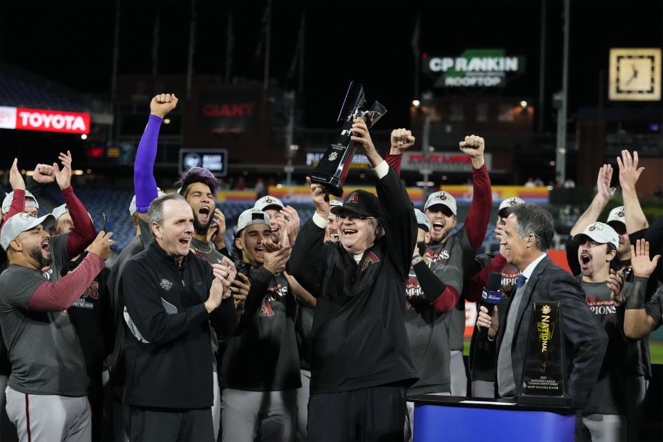 Arizona Diamondbacks owner Ken Kendrick holds up the Warren C. Giles National League Championship trophy after defeating the Philadelphia Phillies 4-2 in Game 7 to win the NLCS during Game 7 of the NLCS at Citizens Bank Park in Philadelphia on Oct. 24, 2023.