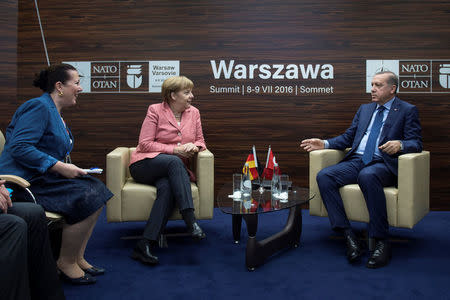 Germany's Chancellor Angela Merkel meets with Turkey's President Tayyip Erdogan at the NATO Summit in Warsaw, Poland July 9, 2016. Bundesregierung/Guido Bergmann/Handout via REUTERS
