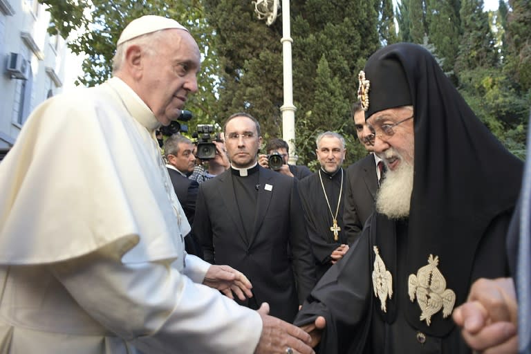 Pope Francis (left) is welcomed by Patriarch Ilia II -- the leader of the Georgian Orthodox church -- during their meeting in Tbilisi, on September 30, 2016