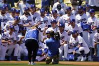 Members of the Los Angeles Dodgers pose for photos with their 2020 World Series Championship ring before a baseball game against the Washington Nationals, Friday, April 9, 2021, in Los Angeles. (AP Photo/Marcio Jose Sanchez)