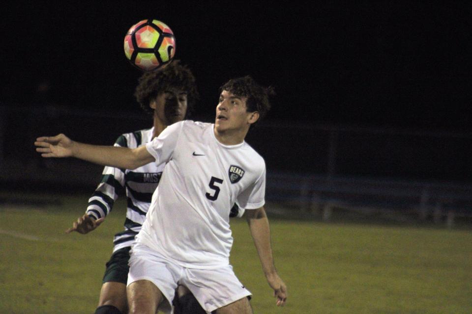 Bartram Trail forward Trey Payne (5) prepares to head the ball against Mandarin during a November game.