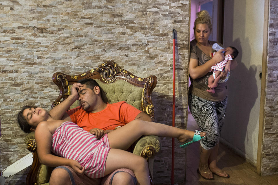 <p>Fernando Montoya Jimenez’s son Manuel, 35, and his daughter rest after being awake all night during Fernando’s eviction in Madrid, July 23, 2014. (AP Photo/Andres Kudaki) </p>