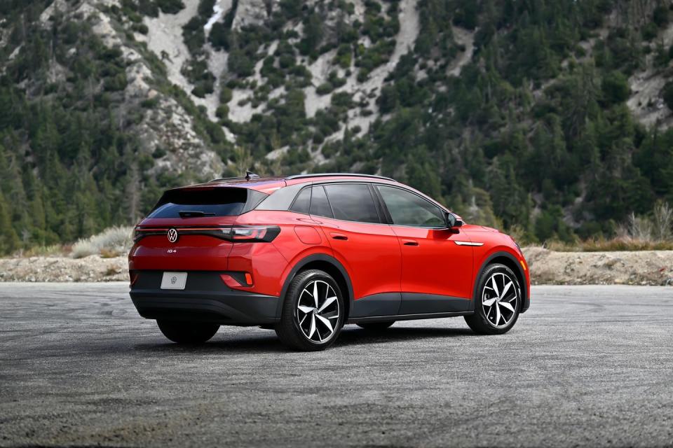 a red 2024 volkswagen id4 parked on a road with trees in the background