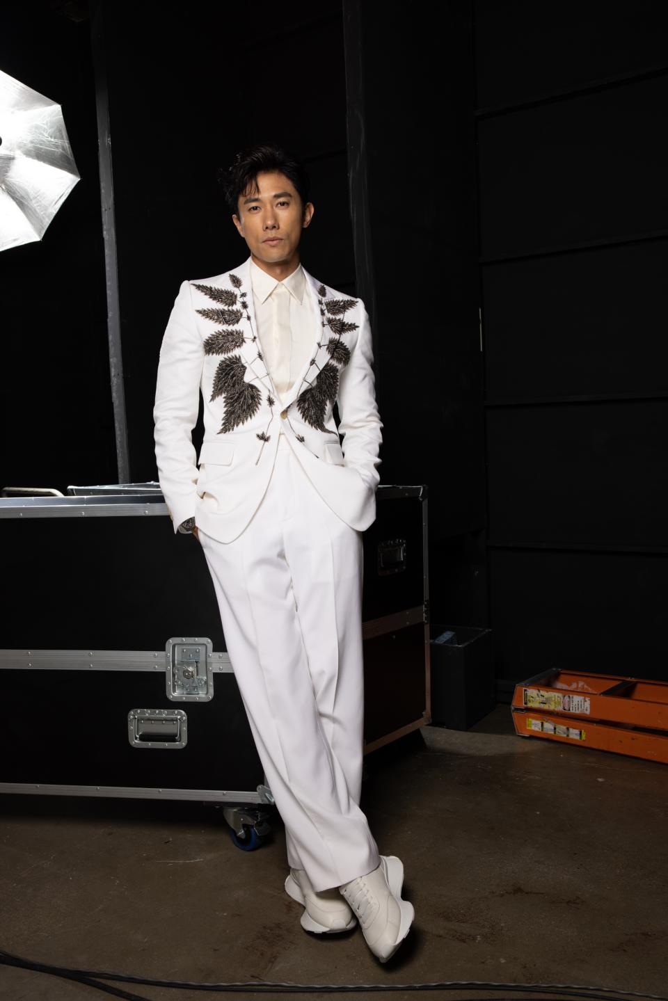 Actor Desmond Tan (陳泂江) wore an ivory single-breasted tailored jacket with silver nettle embroidery and matching wide-legged trousers and Sprint Runner at the annual Star Awards 2023 in Singapore on 9 April. (PHOTO: Alexander McQueen)