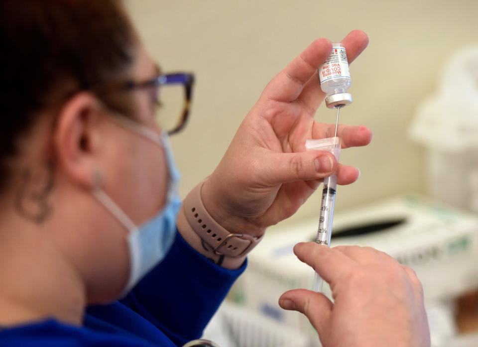 Registered medical assistant Jennifer Roberts prepares a dose of the Moderna COVID-19 vaccine on Friday at InterCare Community Health Network in Benton Harbor, Mich.