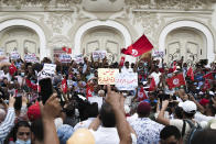 Tunisian demonstrators gather outside the Municipal Theatre of Tunis during a protest against Tunisian President Kais Saied, Saturday, Sept. 18, 2021. In July Tunisian President Kais Saied fired the country's prime minister and froze parliament's activities after violent demonstrations over the country's pandemic and economic situation. The movement made by Saied was considered by his opponents as a coup. (AP Photo/Riadh Dridi)