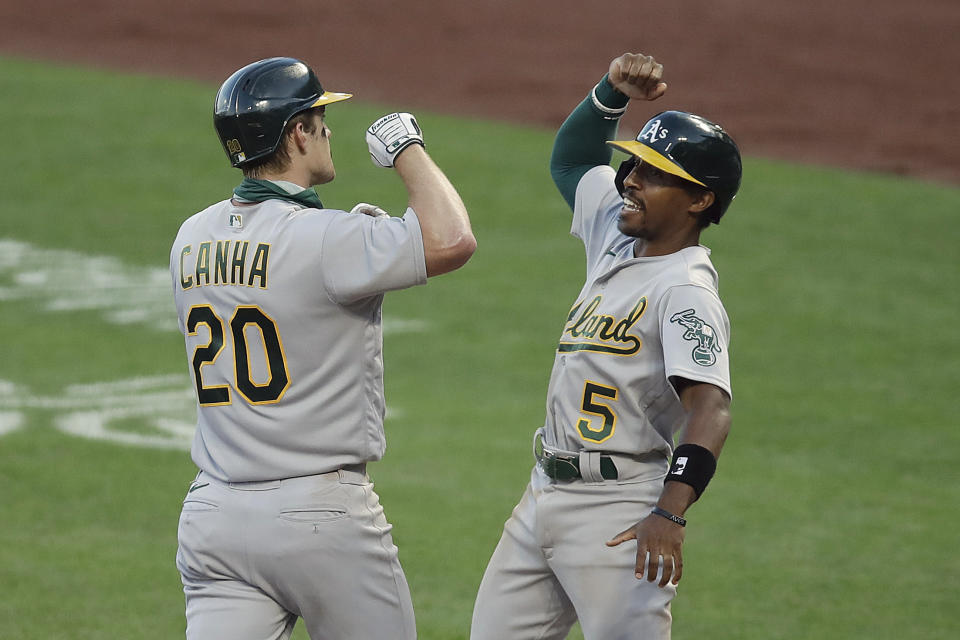 Oakland Athletics' Mark Canha (20) celebrates with Tony Kemp, right, after hitting a three run homerun off San Francisco Giants' Trevor Gott in the ninth inning of a baseball game Saturday, Aug. 15, 2020, in San Francisco. (AP Photo/Ben Margot)
