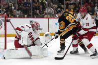 Carolina Hurricanes goaltender Pyotr Kochetkov, left, blocks a shot as Brady Skjei (76) defends Pittsburgh Penguins' Lars Eller (20) during the second period of an NHL hockey game in Pittsburgh, Tuesday, March 26, 2024. (AP Photo/Gene J. Puskar)