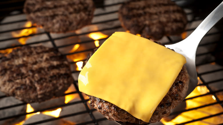 Melting American cheese on burger 
