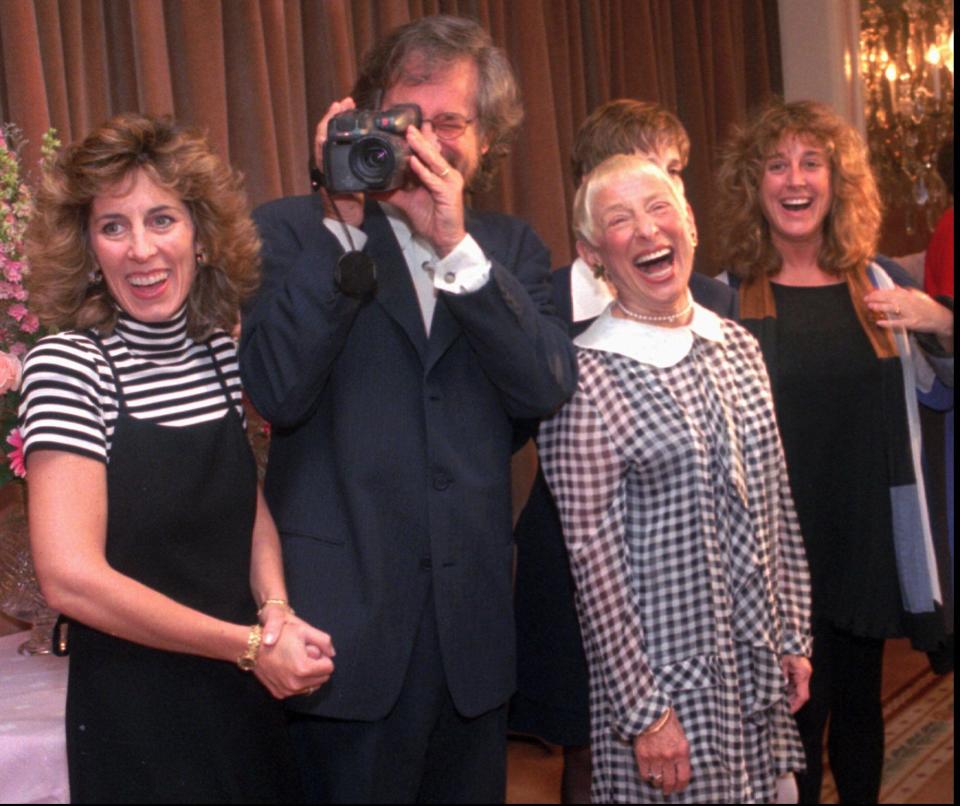 Steven Spielberg points a video camera at photographers as he poses with his mother Leah Adler, front center, and his sisters, from left, Nancy, Sue and Anne in 1995 in Beverly Hills, Calif.