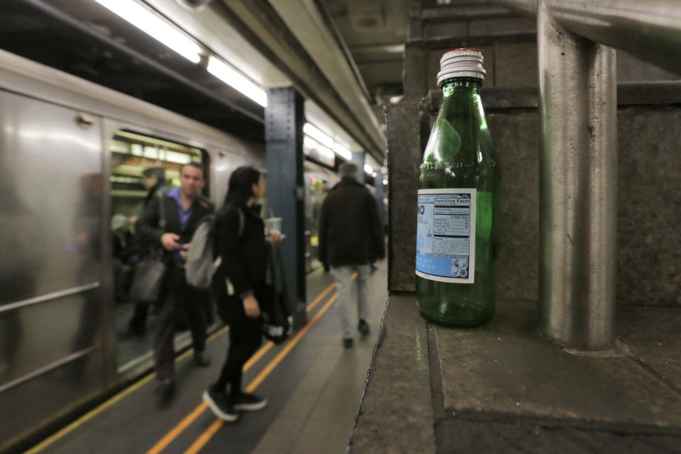 An empty water bottle is left on stairs in the Wall Street subway station, in New York, Thursday, March 30, 2017. Faced with the problem of too much litter and too many rats in their subway stations, New York City transit officials began an unusual social experiment a few years ago. They removed trash bins entirely from select stations, figuring it would deter people from bringing garbage into the subway in the first place. This week, they pulled the plug on the program after reluctantly concluding that it was a failure. (AP Photo/Richard Drew)