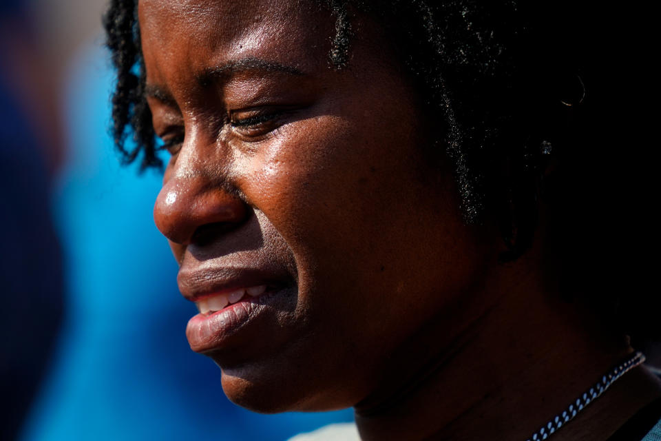 A person is overcome with emotions outside the scene of a shooting at a supermarket, in Buffalo, N.Y., Sunday, May 15, 2022. (AP Photo/Matt Rourke)