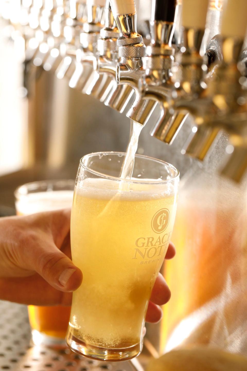 Jeremy Baker pours a glass of his Da Capo American-style lager from the tap at Grace Note Brewing in Jacksonville.