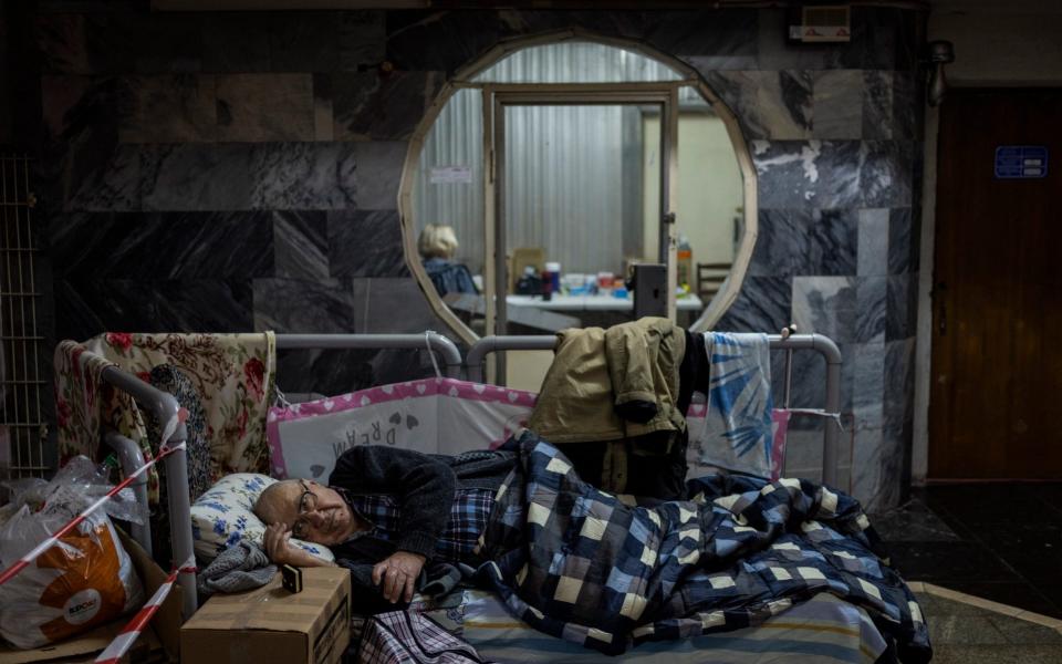 An elderly man rests in a city subway used as a temporary bomb shelter in Kharkiv, eastern Ukraine, May 19, 2022. Although the bombings in Kharkiv have become less frequent and the subway is expected to resume service from next week, some residents still use it as a temporary bomb shelter.  - Bernat Armangue/AP