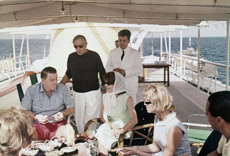 FILE - This is a 1963 file photo of Aristotle Onassis, standing with black shirt, as he joins, Jaqueline Kennedy and Franklin Roosevelt Jr., on board the Onassis yacht Christina in the Mediterranean. Mrs. Kennedy was a guest of Onassis after the death of her infant son. The yacht that belonged to the late Greek shipping magnate Aristotle Onassis is up for sale with an asking price of 25 million euros ($32.4 million). Yacht broker Nicholas Edmiston said Wednesday July 3, 2013 he believes there are about 10 people in the world who might be interested in buying the Christina O. (AP Photo/File)