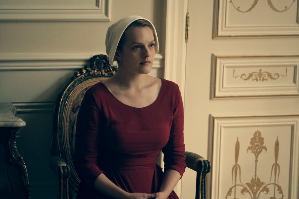 Elisabeth Moss sitting in a chair in "The Handmaid's Tale"